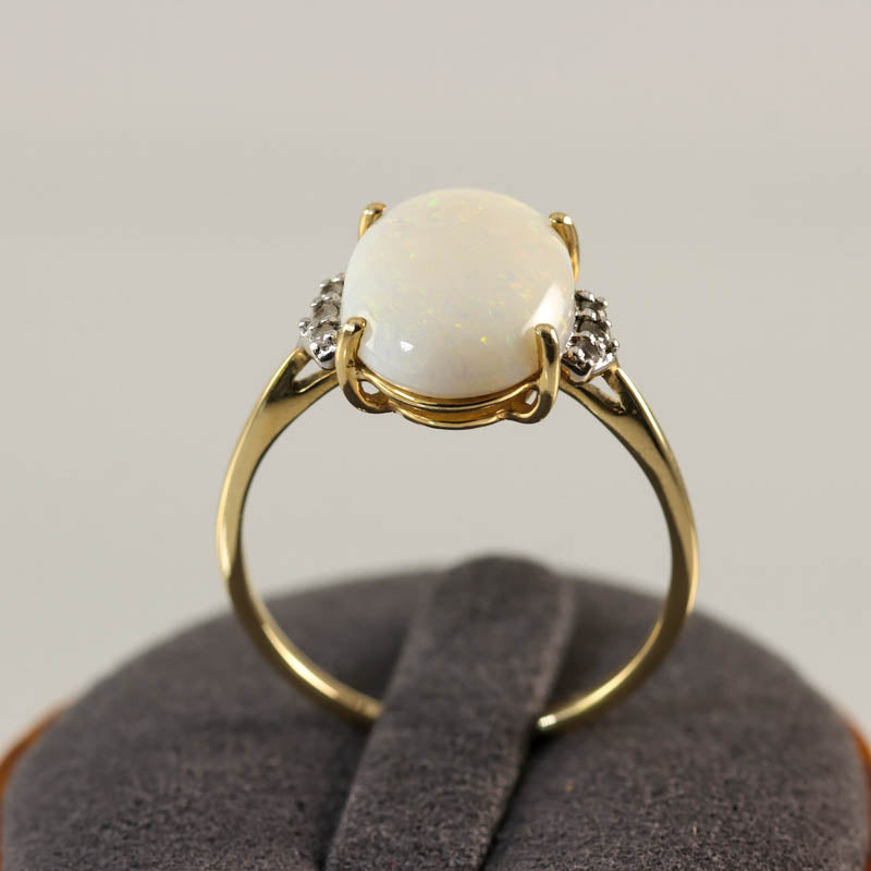 10Ct Gold Opal & White Sapphire Dress Ring — displayed on ring stand